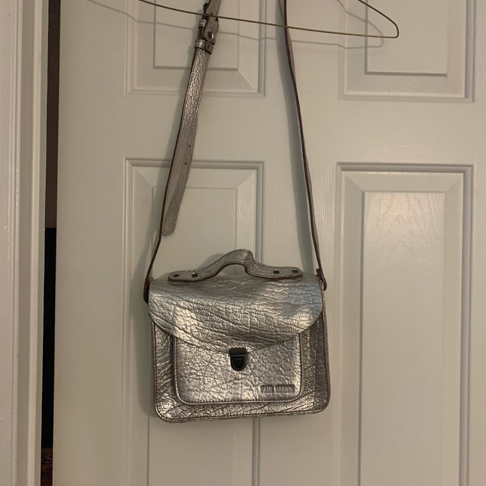 Brand new silver leather crossbody bag.  Never used. 9.5 in(w) x 8 in(l) x 2.5